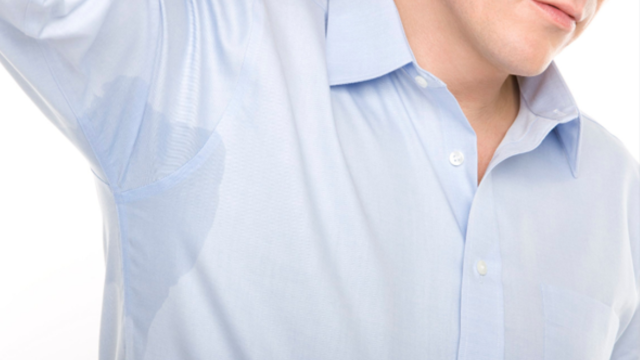 close up of man with sweat in arms to show surprising causes of excessive sweating 