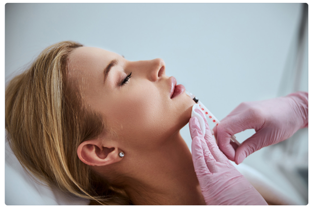 A woman getting lip filler treatment to show whether or not it's painful 